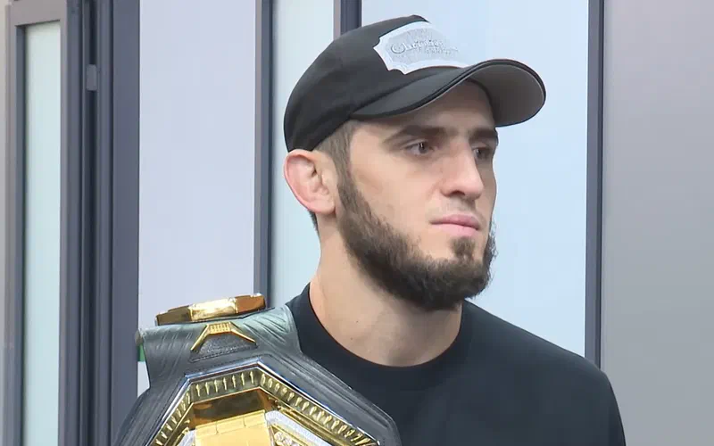 Islam Makhachev holding the UFC lightweight championship belt over his shoulder, October 2022