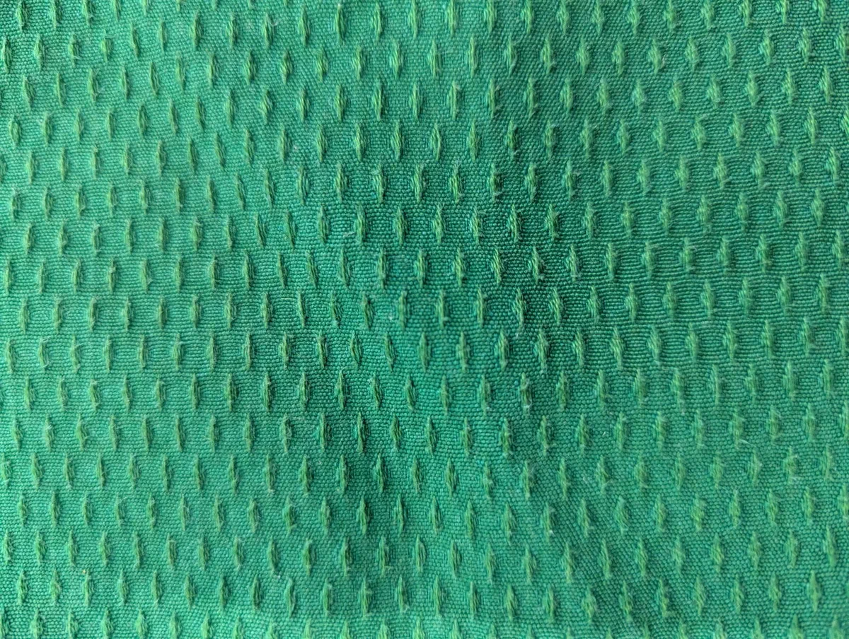 The special dotted weave of a green jacket