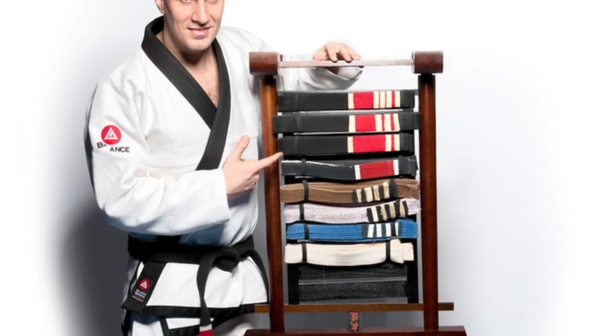 Black belt Phil Migliarese with every belt he earned over 20 years