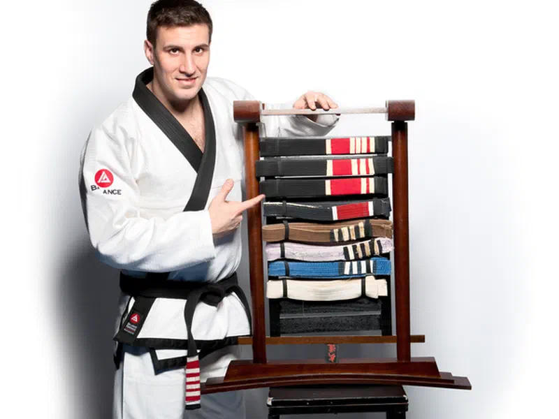 Black belt Phil Migliarese with every belt he earned over 20 years
